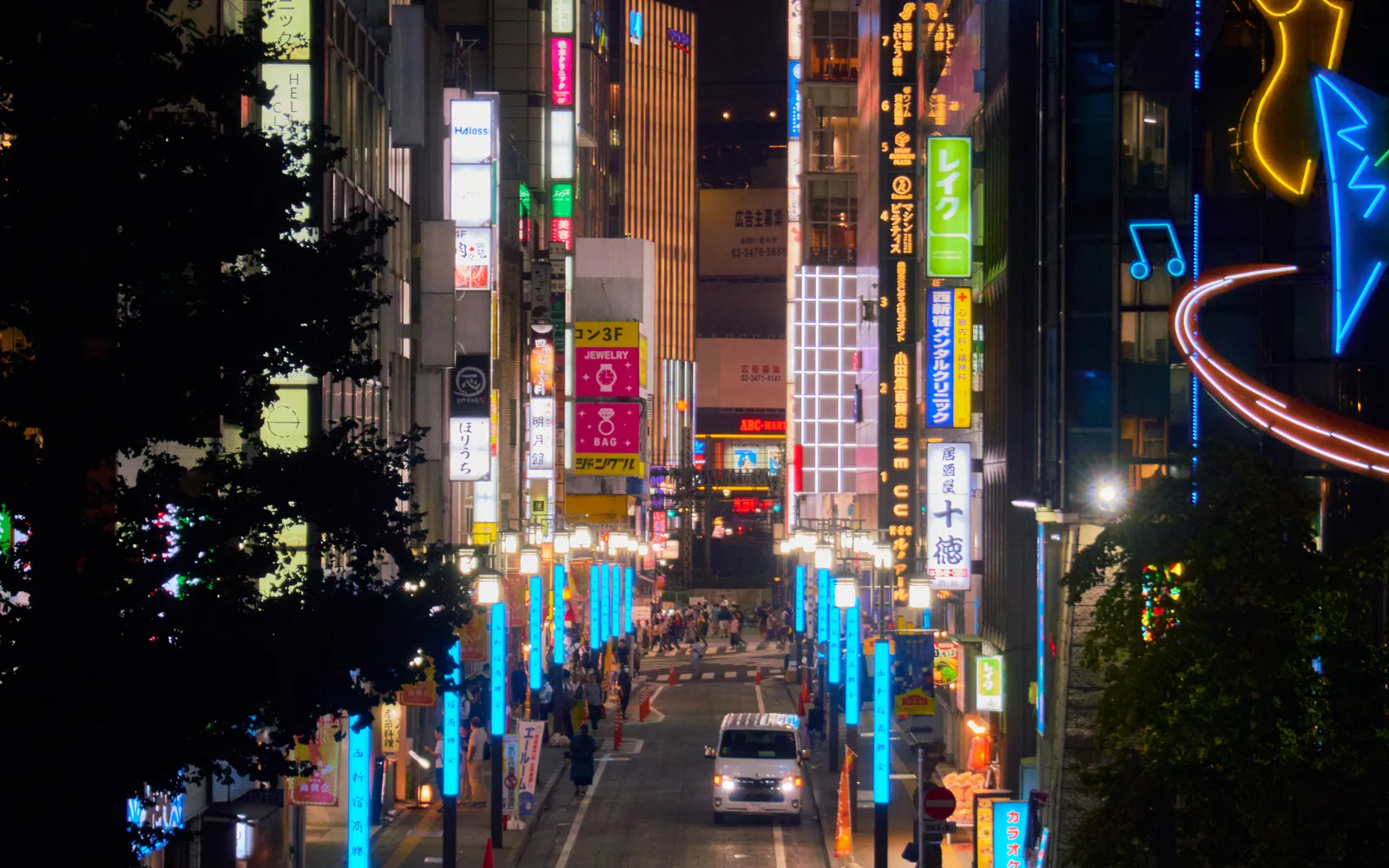 Neon signs along a commercial street in Shinjuku at night